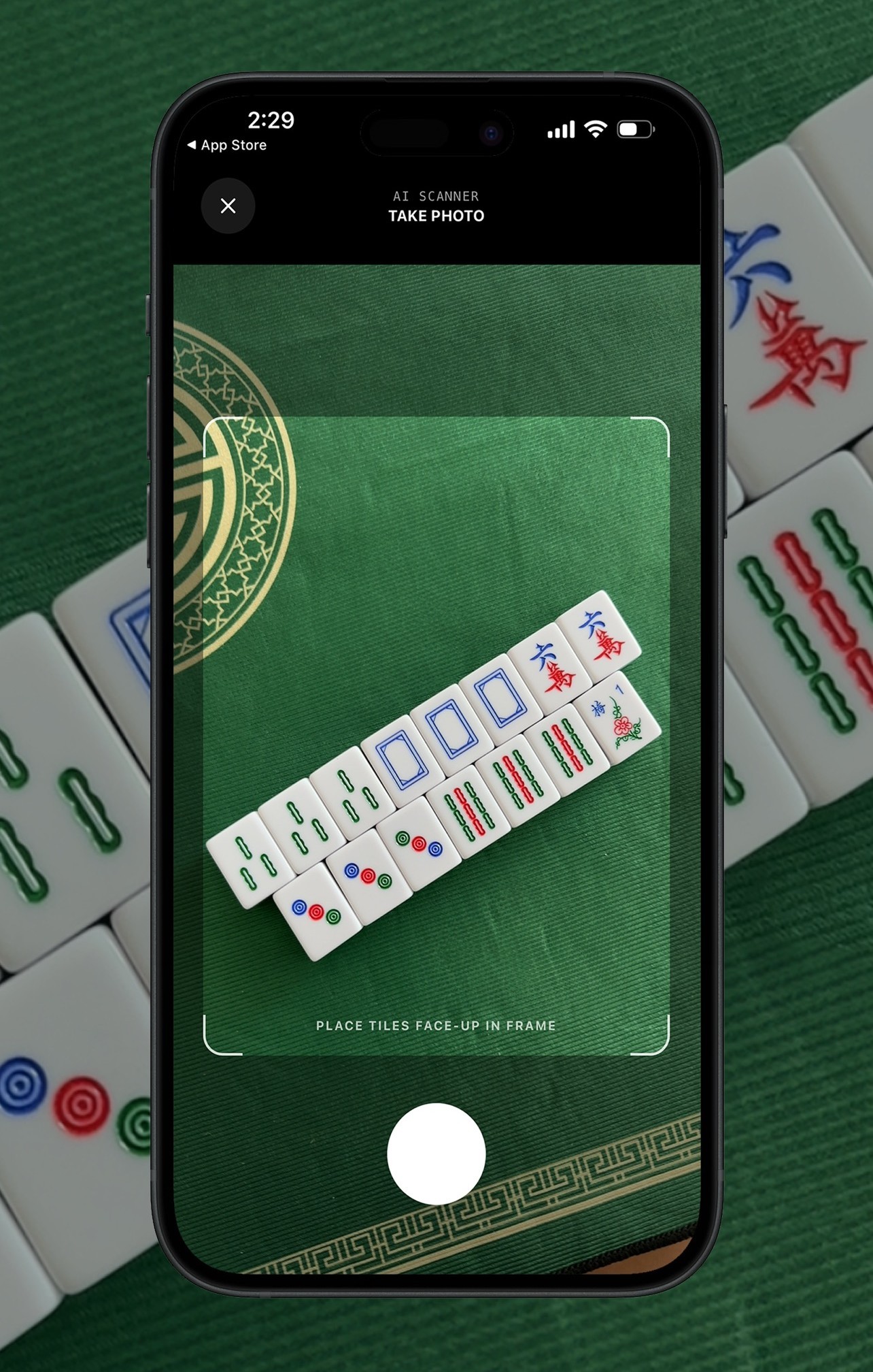TileBuddy AI scanner photographing a mahjong hand on the table